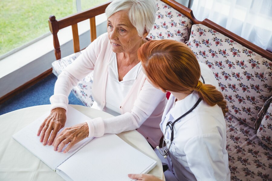 nurse-helping-senior-woman-with-braille